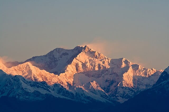 Morning sunlight hits the summit of Kangchenjunga in the Indian Himalayas